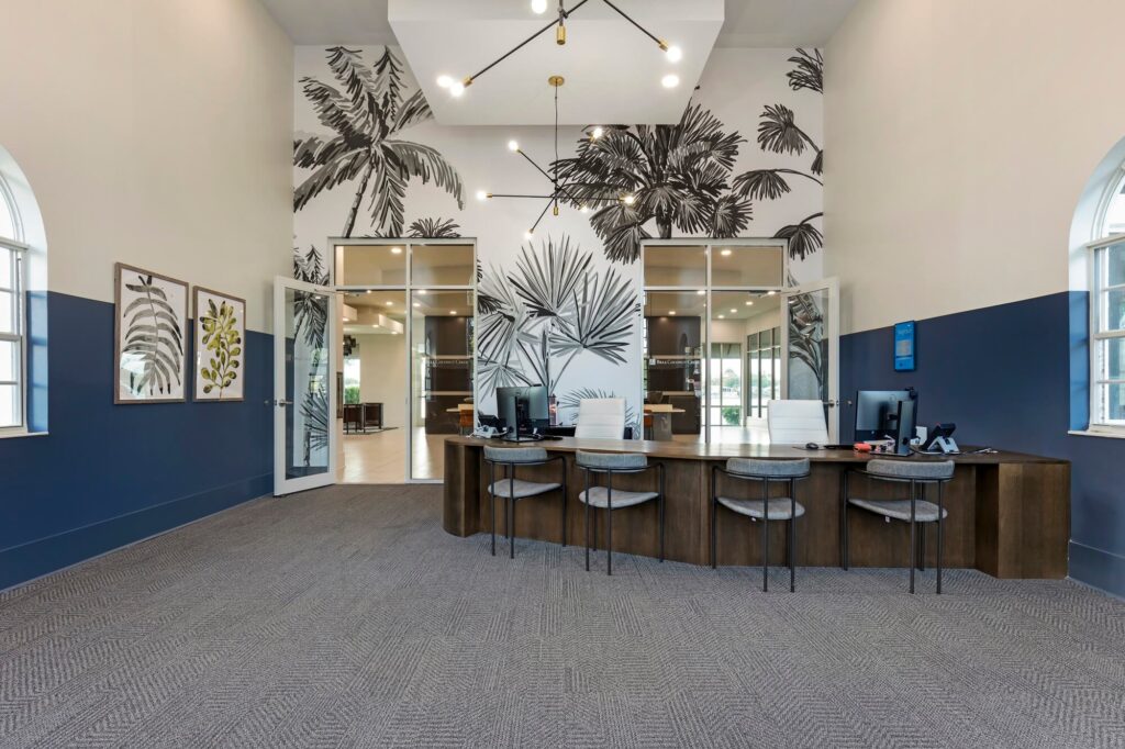 Leasing office employee desks with floral mural on the back wall