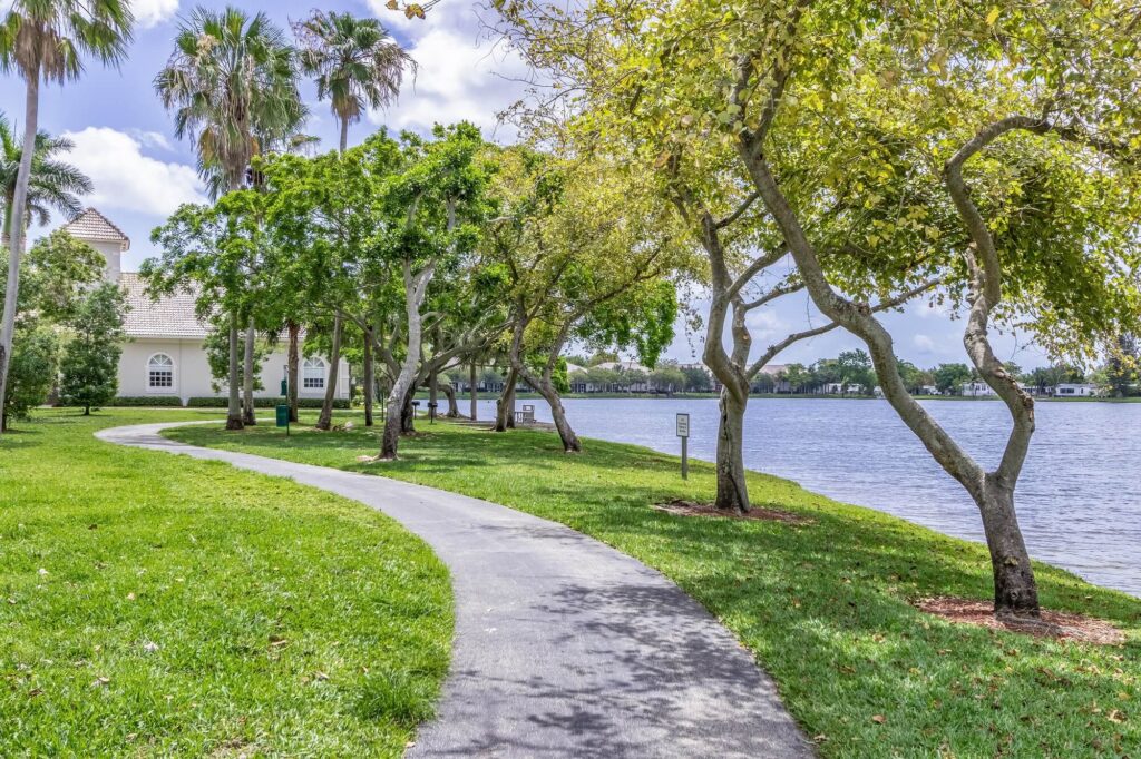 Walking path by lake with residential building