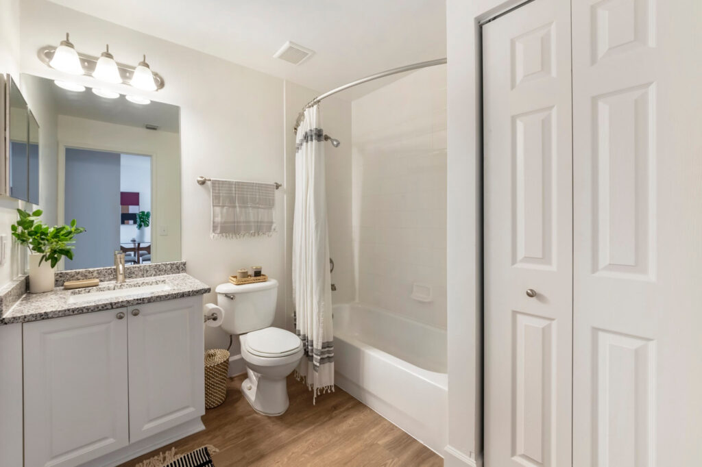 Bathroom with granite counter and large mirror