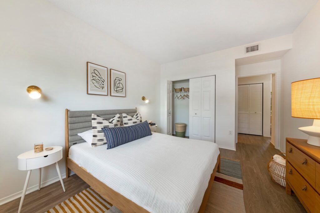 Bedroom with wood floors, closet and access to the hallway