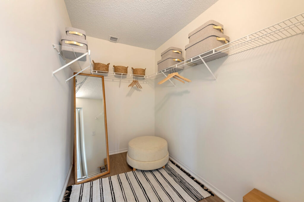 Walk in closet with wood floor