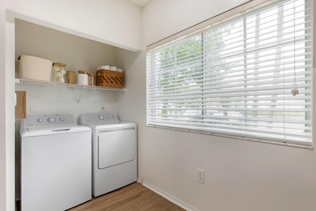 Model apartment laundry room with large window